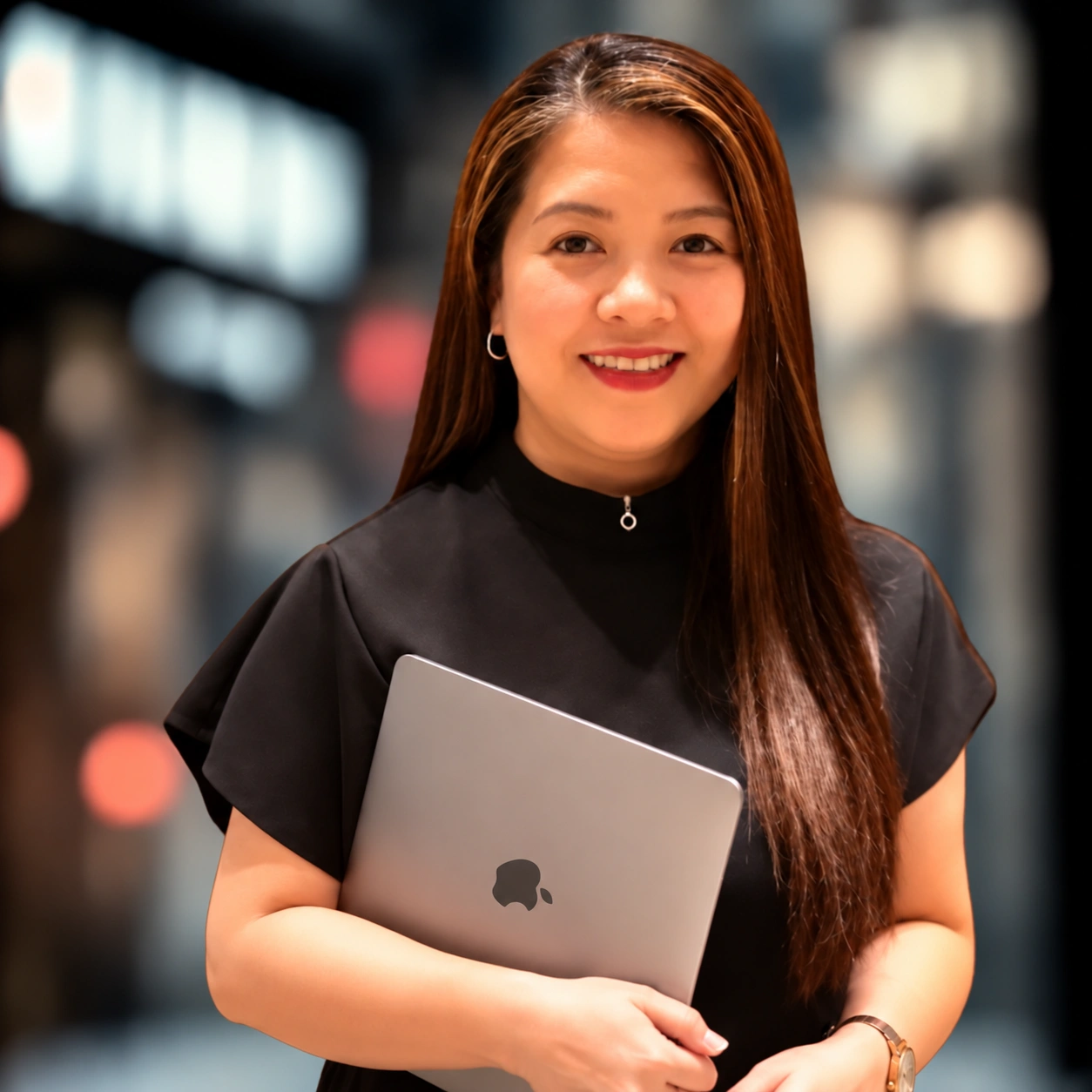 Rhoda Santos holding a laptop
